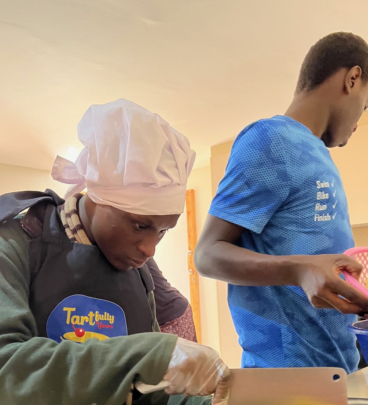 Samuel cutting pineapples for Tartfully Yours